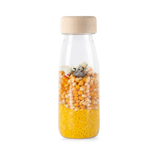 Bouteille sensorielle Ferme avec grains de maïs jaunes et figurine animale