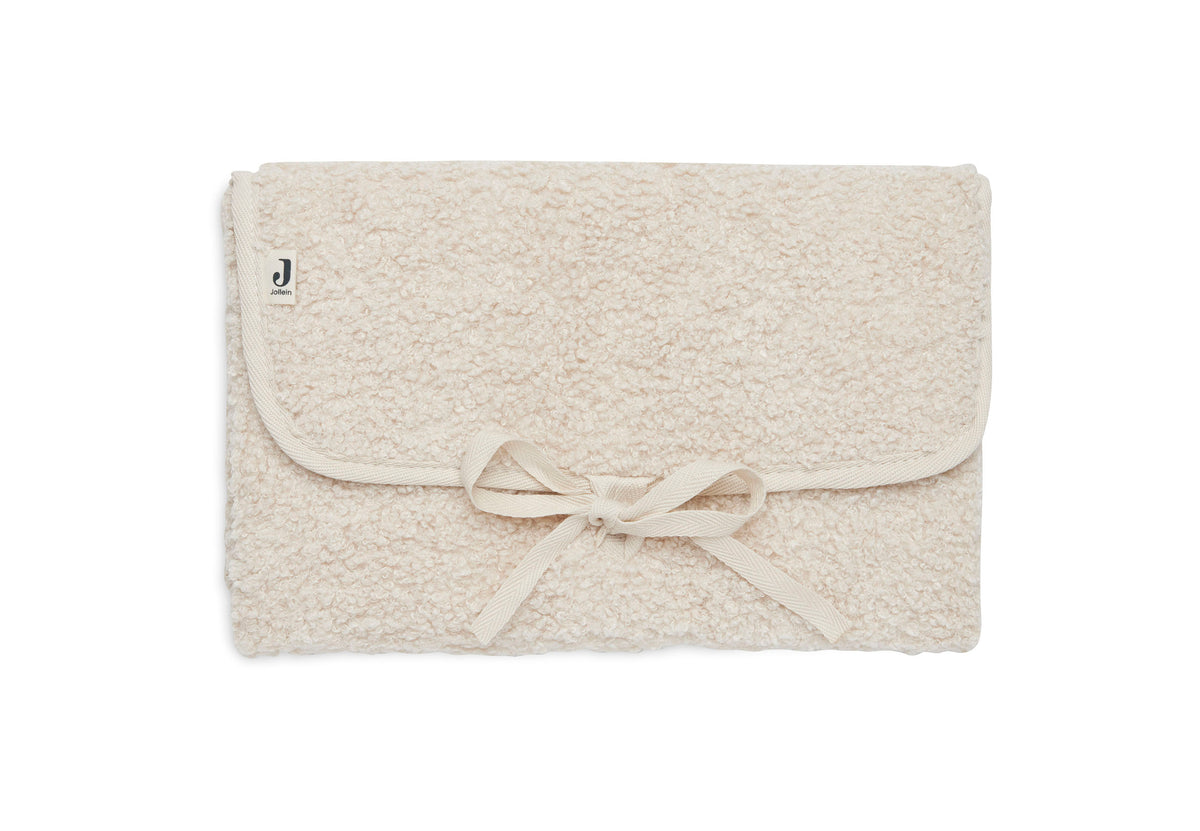 Tapis à langer nomade en tissu bouclette naturel, plié avec liens